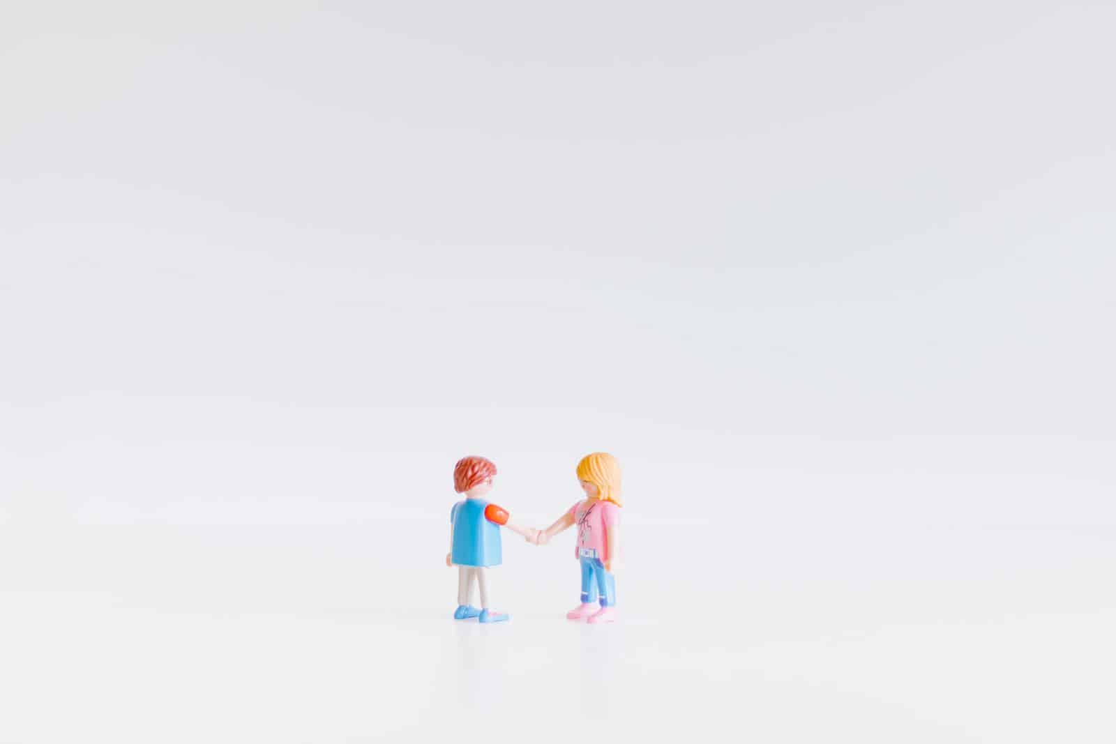 Toy figures shaking hands