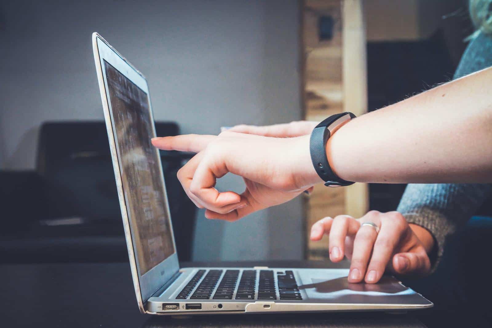 Person pointing to a screen