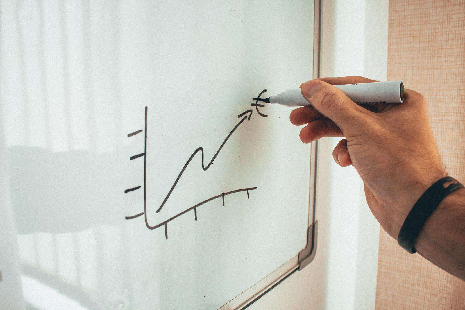 Person drawing chart on whiteboard