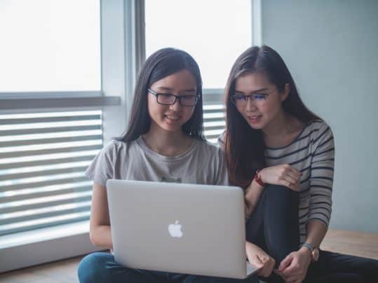 Girls with glasses using laptop